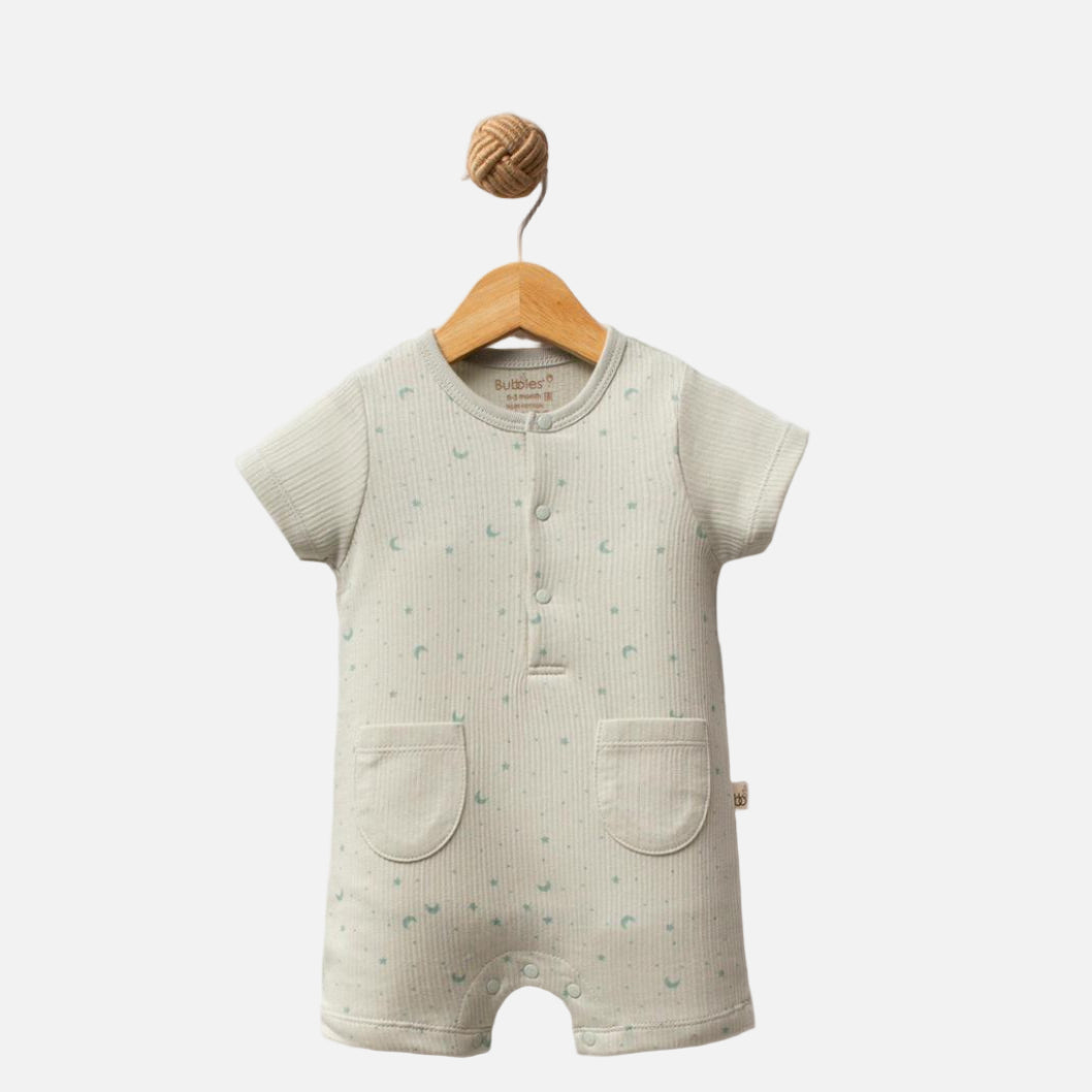 Baby romper with short sleeves and legs on a wooden hanger against a white background