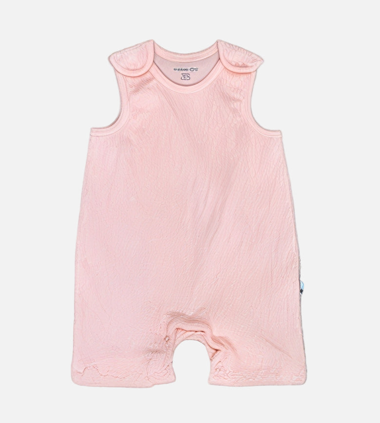 Pink baby romper with ruffled neckline on a gray background