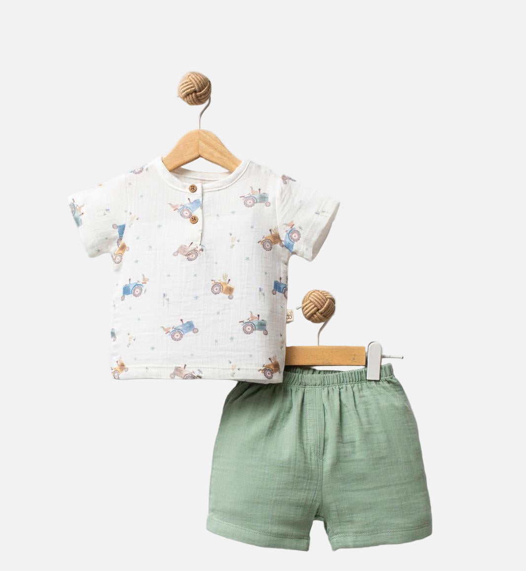 Children's outfit with a white shirt and green shorts on a white background, featuring 'Tractor' branding.