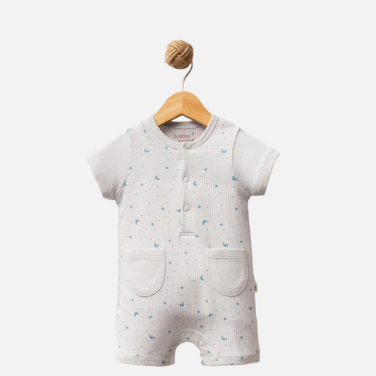 Baby romper with star pattern on a wooden hanger against a white background