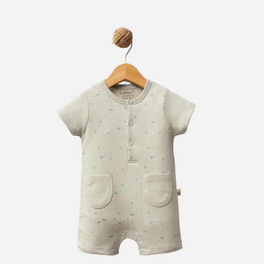 Baby romper with short sleeves and legs on a wooden hanger against a white background