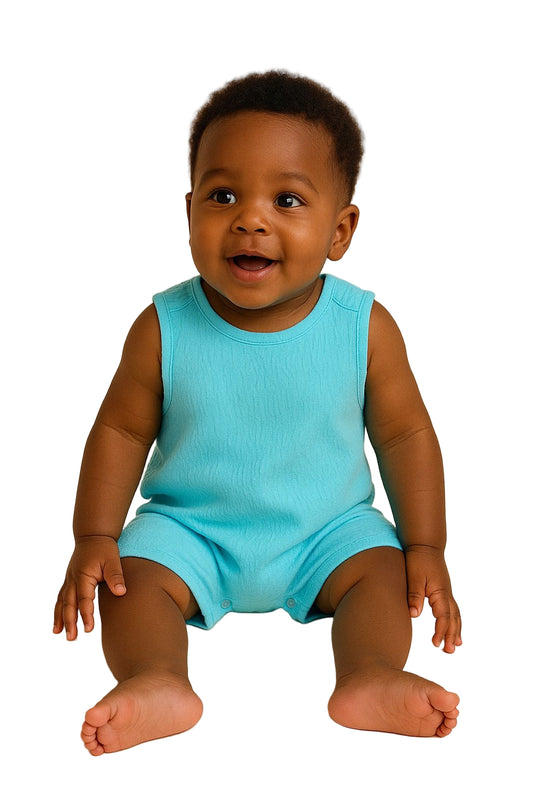 Baby wearing a blue romper sitting on a beige background