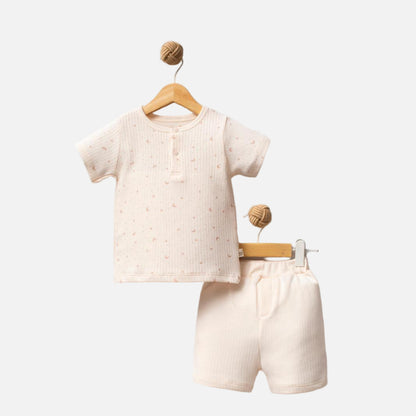 Children's beige outfit with shirt and shorts on hangers against a white background, featuring 'Shiny Moon' brand.