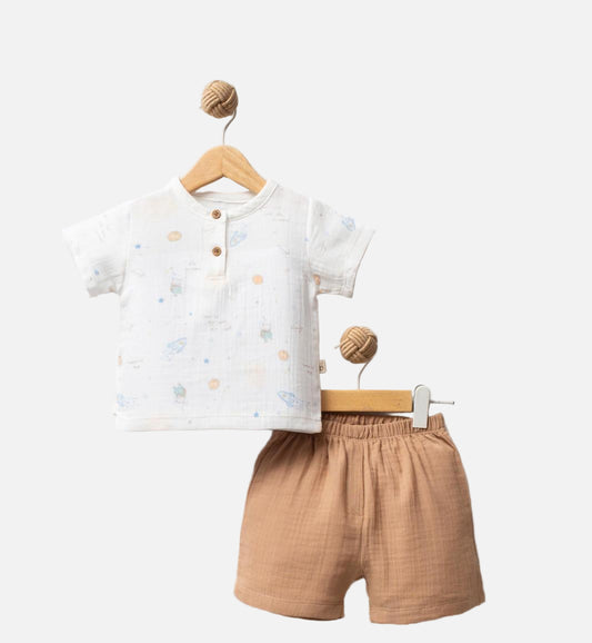 Children's outfit with a white shirt and brown shorts on hangers against a white background