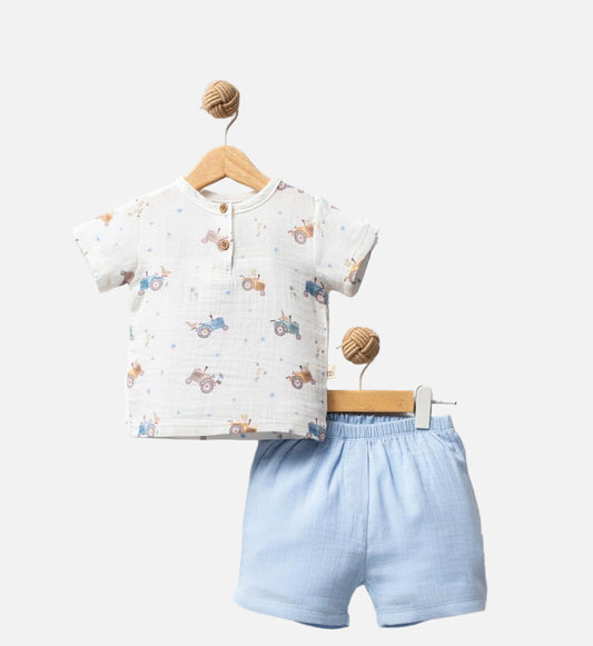 Baby outfit with white shirt and blue shorts on a hanger against a white background, featuring 'Tractor' branding.