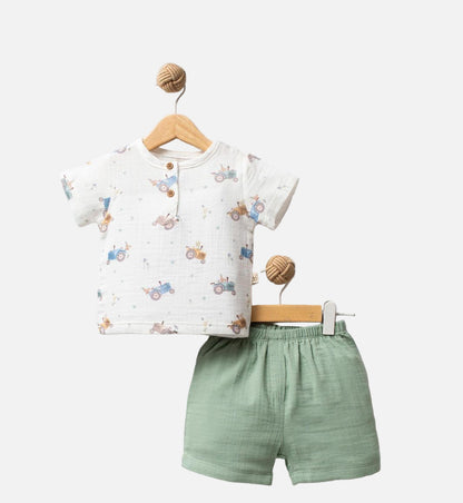 Children's outfit with a white shirt and green shorts on a white background, featuring 'Tractor' branding.