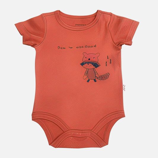 Red baby onesie with a fox design on a white background
