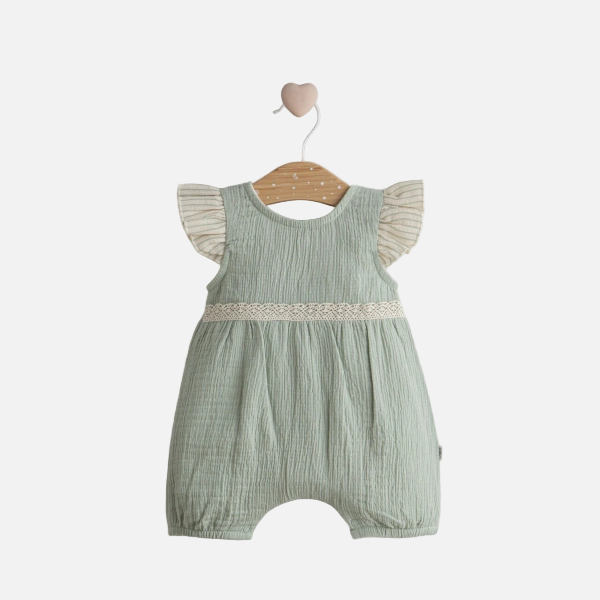Green baby romper with ruffled sleeves on a wooden hanger against a light gray background
