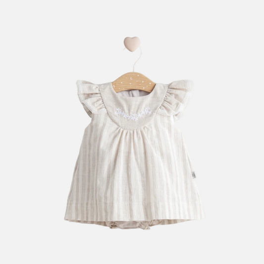 Baby dress with ruffled sleeves on a wooden hanger against a white background