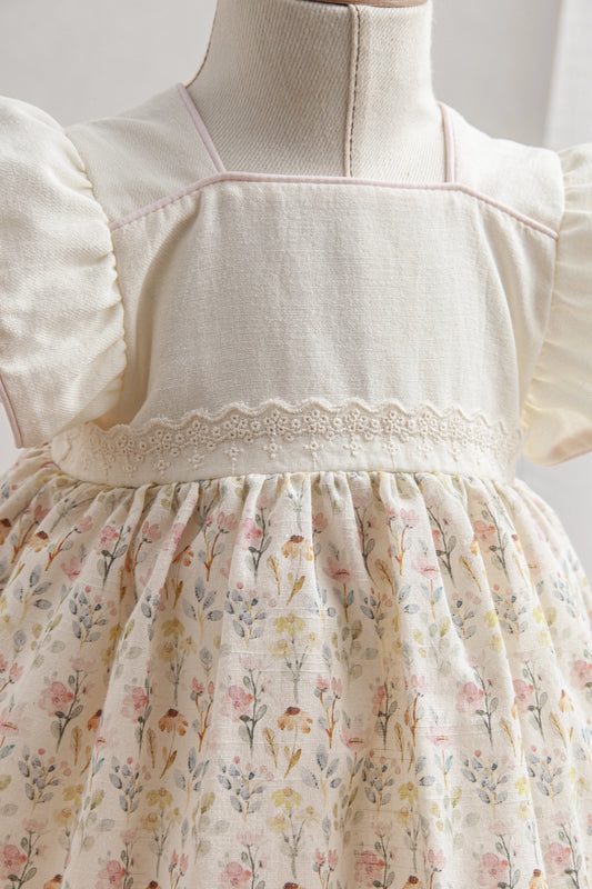 Mannequin wearing a white blouse with puffed sleeves and a floral skirt.
