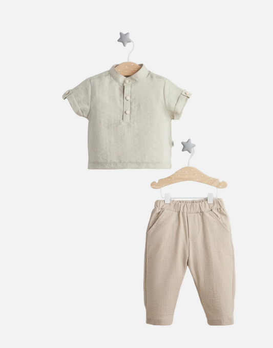 Children's outfit with shirt and pants on hangers against a white background